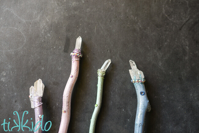 Four pastel, sparkly Luna Lovegood inspired Harry Potter magic wands topped with quartz crystals.