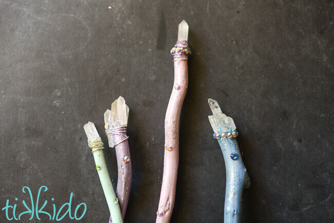 Four pastel, sparkly Luna Lovegood inspired Harry Potter magic wands topped with quartz crystals.
