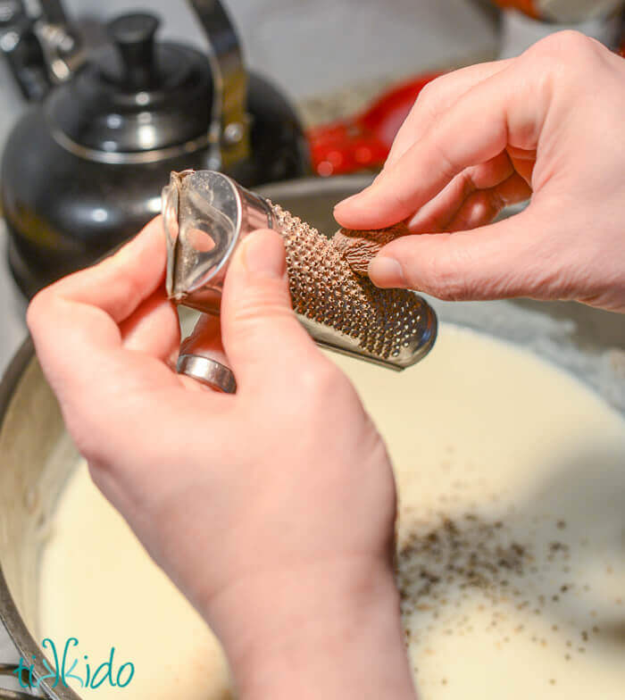 Nutmeg being grated into the sauce for Baked Macaroni and Cheese.