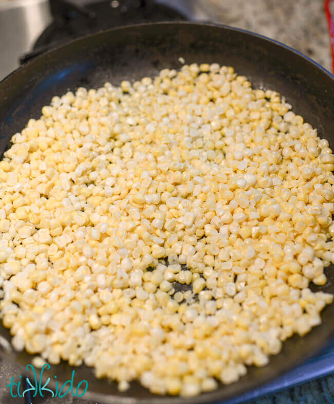Fresh sweet corn kernels being pan roasted for Mexican Street Corn Salad