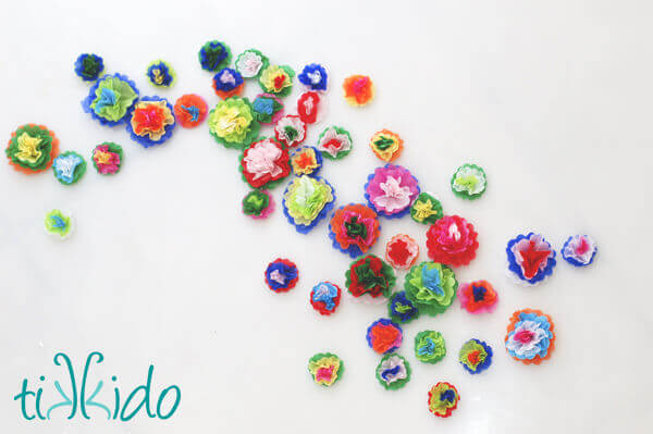 Colorful Mexican style miniature tissue paper flowers on a white background.