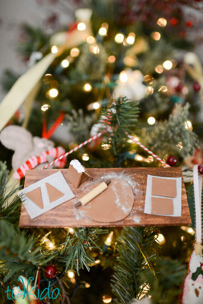 Gingerbread baking Christmas ornament hung on a Christmas tree