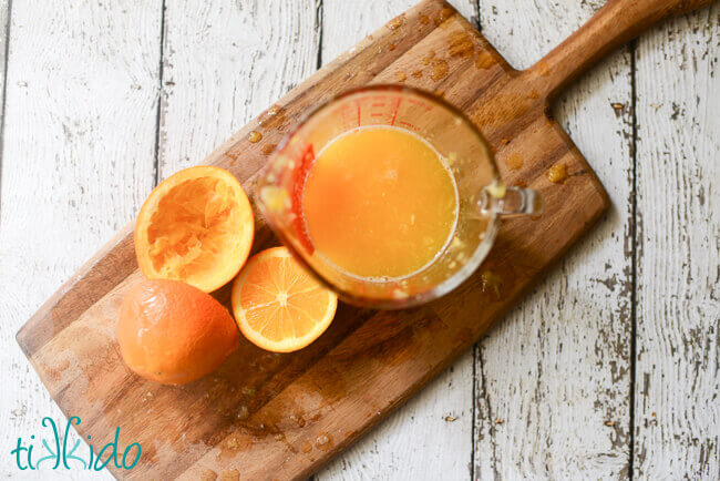 Freshly squeezed orange juice in a pyrex measuring cup.