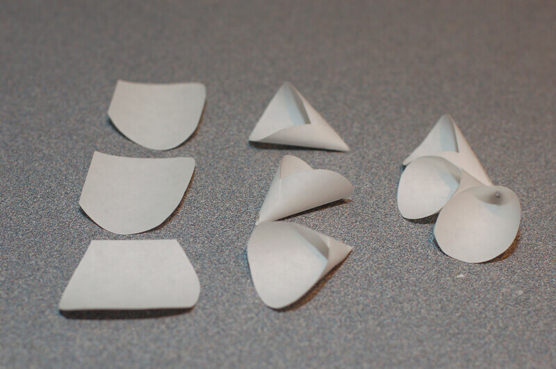 Picture showing paper petals being rolled into cones and assembled together to create a rolled cone style paper flower