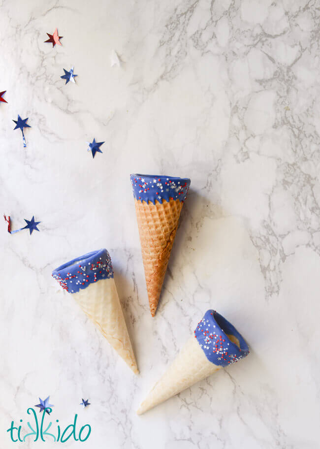 Red, white, and blue ice cream cones with chocolate and sprinkles.