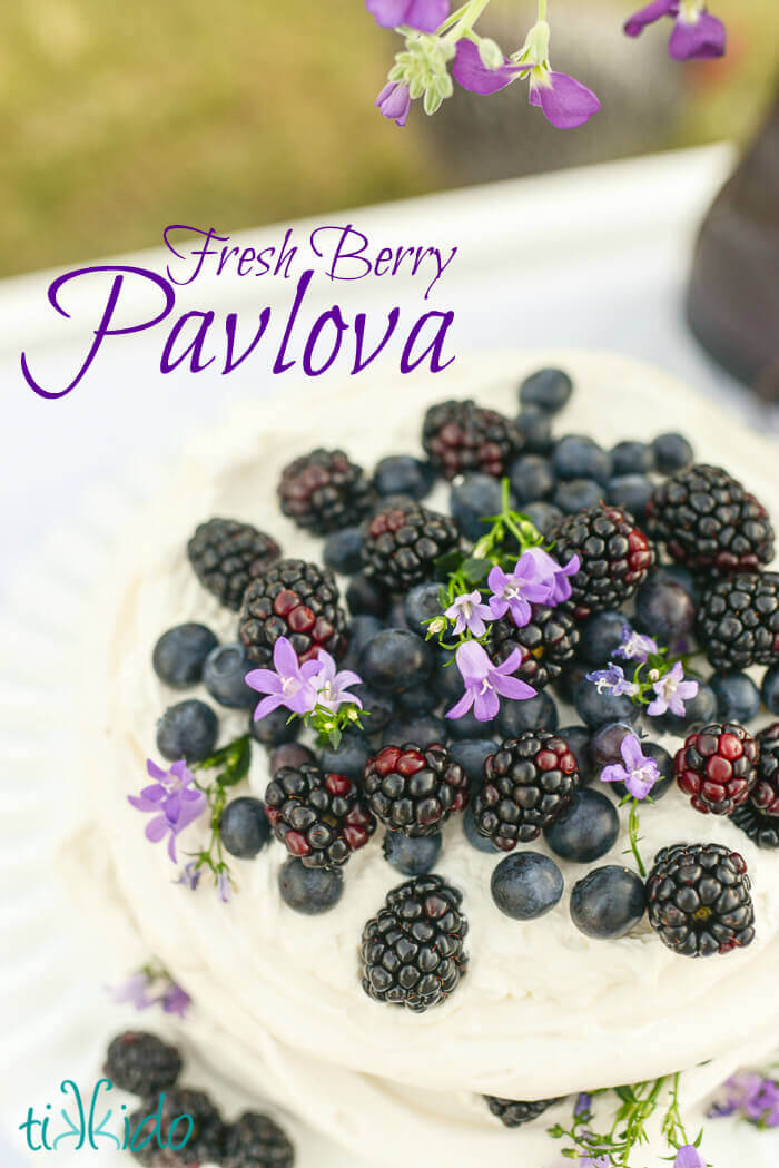 Recipe for pavlova with whipped cream, blackberries, and blueberries.