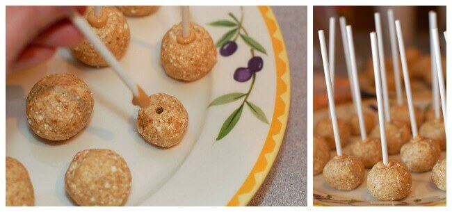 Healthy peanut butter balls being put on sticks.