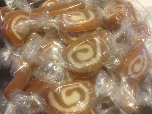 Homemade caramel creme candies wrapped in cellophane.