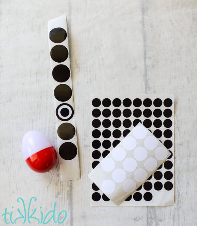 Decorating the pokemon easter eggs with black and white round stickers.