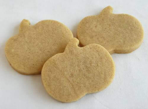 Brown sugar spice cut out sugar cookies cut into pumpkin shapes.