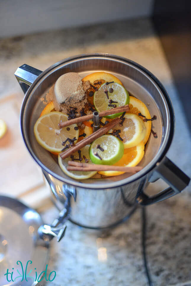 Mulled apple cider ingredients in a percolator.