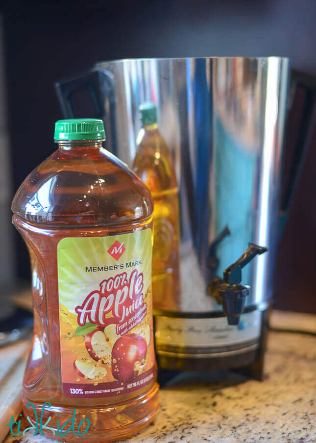 Apple juice next to percolator for making mulled cider in a coffee percolator.