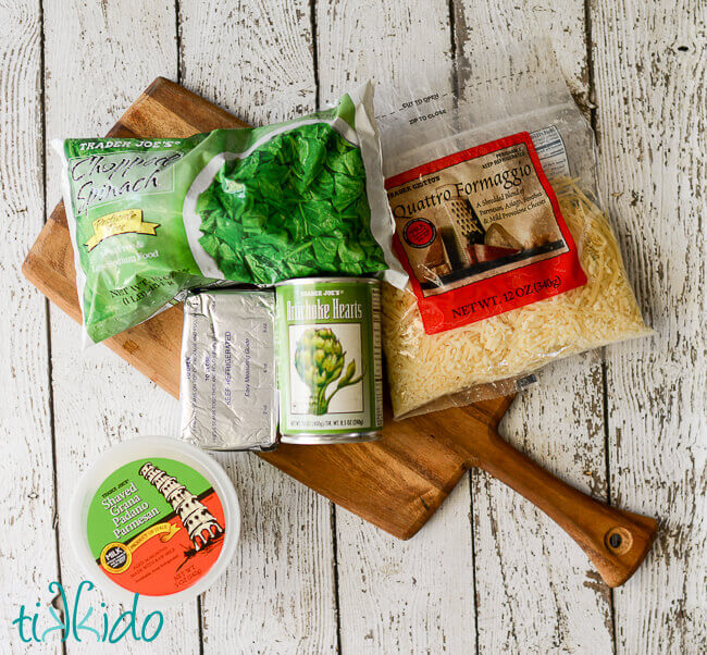 Light Spinach Artichoke Dip recipe ingredients on a wooden cutting board.