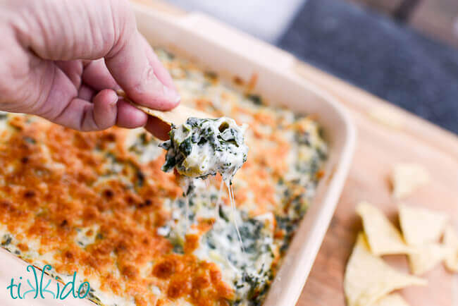 A tortilla chip loaded with light spinach artichoke dip.