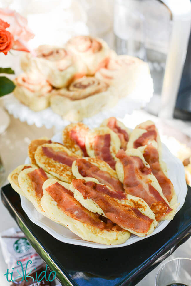 Bacon pancakes on a white plate on a brunch table.