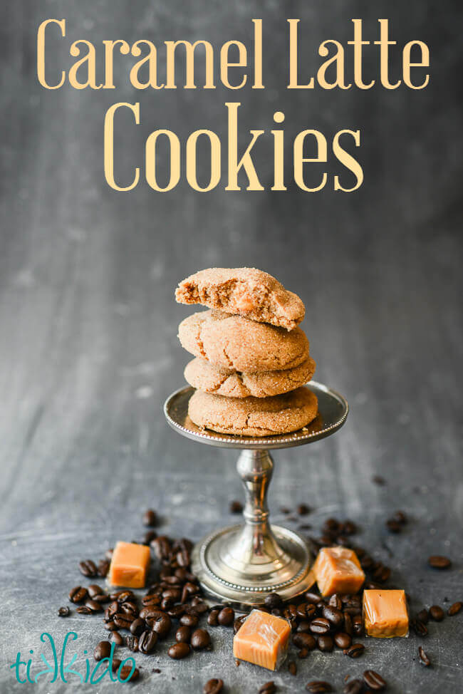 Coffee flavored cookies filled with caramel stacked on a small stand, surrounded by coffee beans and caramel candies.