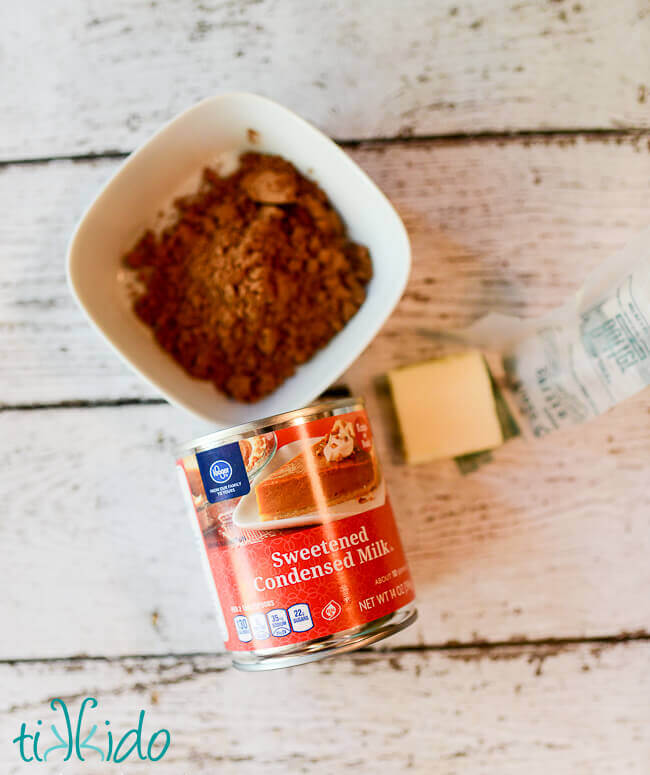 brigadeiro Recipe ingredients on a weathered white wooden background.