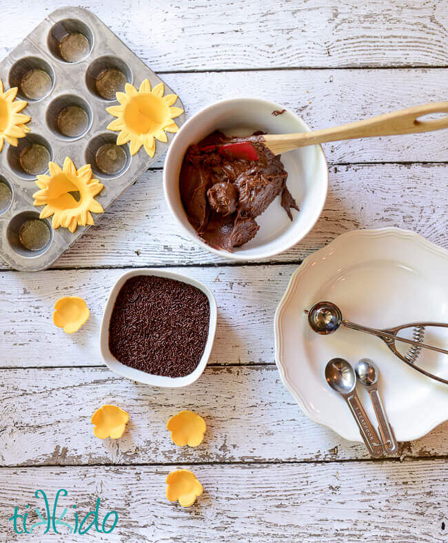 brigadeiros being rolled in chocolate sprinkles