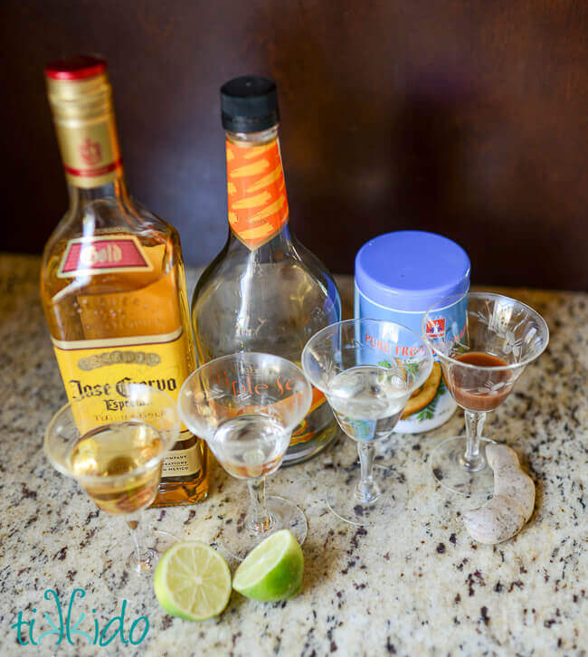 tequila, lime juice, triple sec, and tamarind concentrate in bottles and portioned in four small glasses.