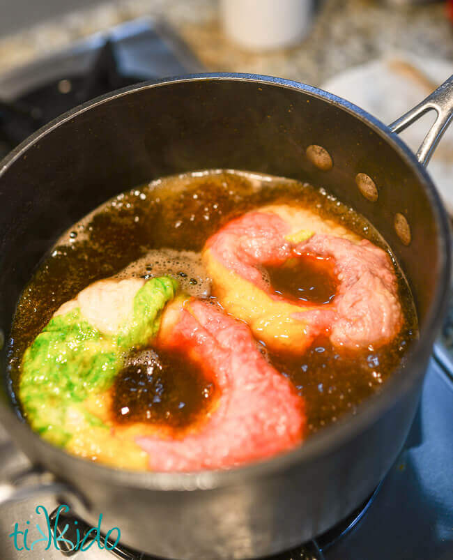 Unicorn bagels being boiled before baking.