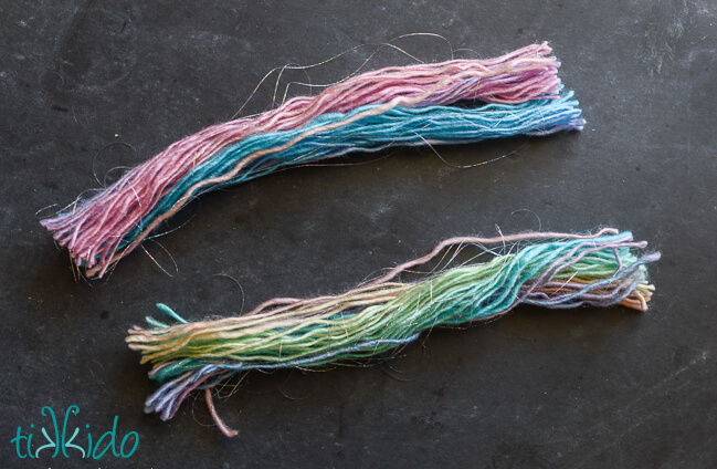 Pastel rainbow yarn for yarn tassels being cut to length.