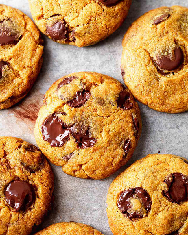 Vegan pumpkin chocolate chip cookies on parchment paper.