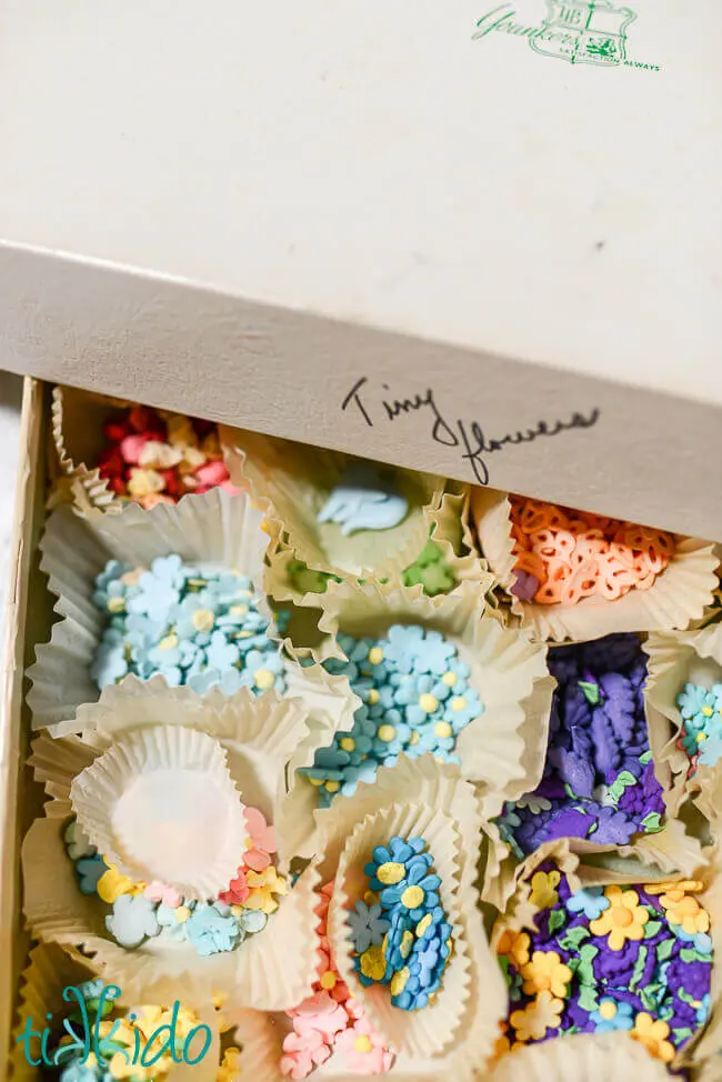 Vintage Royal icing decorations in cupcake liners in a cardboard box.