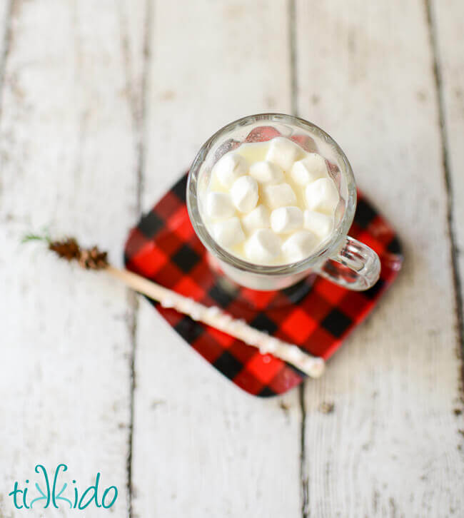 White hot chocolate topped with marshmallows in a clear mug.