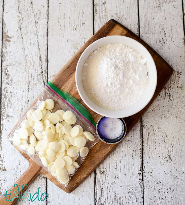 White hot chocolate mix ingredients on a wooden cutting board.